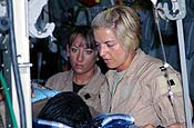 Air Force Master Sgt. Theresa Sheheen (left), 455th Expeditionary Aeromedical Evacuation Flight medical technician, and Air Force Capt. Michelle Mulberry, 455th EAEF flight nurse, tend to a litter patient on an aeromedical evacuation mission from Bagram Airfield, Afghanistan. Mulberry and Sheheen are deployed from the Wyoming Air National Guard's 187th Aeromedical Evacuation Squadron, Cheyenne, Wyo. (Photo by Staff Sgt. Craig Seales Combined Joint Task Force - 82 PAO)
