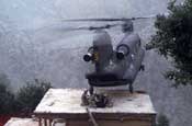 A Pennsylvania Army National Guard CH-47D Chinook helicopter from Company G, 104th Aviation, lands on the roof of a house in Nuristan Province, Afghanistan to pick up suspects during Operation Mountain Resolve in November 2003.