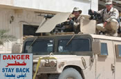 Cpl. David Segrest (left), radio operator, and Sgt. Tracey Sourbeck, heavy equipment repairman, Explosive Hazards and Awareness Team, 200th Engineer Battalion, Alabama Army National Guard, teamed up and designed a safer and more equipped gun mount system for the turret of their unit Humvees. Their modifications allow for a second weapon, more firepower and better protection for Humvee gunners. The two are deployed to Camp Victory, Iraq, in support of Operation Iraqi Freedom. Sourbeck, 42, is a native of Enterprise, Ala. Segrest, 31, is from Jasper, Ala. (U.S. Army photo by Sgt. Michael J. Carden)