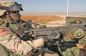 Tennessee National Guardsman, Sgt. Joshua Dumont, engineer, 386th Combat Engineer Battalion, Task Force Liberty, charges his Browning M-2 .50 Caliber heavy machine gun after leaving the security gate of Foward Operating Base Cladwell, in Iraq.