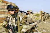 SPC Justin Tucker from the 940th MP Company out of Walton Kentucky, along with a Soldier from the Mongolian Military provide security during a joint patrole, in the town of Al Hillah, Iraq on May 14 2005. (U.S. Army Photo by SGT Hamilton, Arthur)