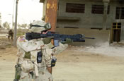 SSG Donald Wagers from the 940th MP Company out of Walton Kentucky, provides security during a joint patrole, in the town of Al Hillah, Iraq on May 14 2005. (U.S. Army Photo by SGT Hamilton, Arthur)