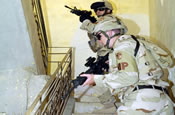 Soldiers from the 940th MP Company out of Walton Kentucky, search a small building during a joint patrole, in the town of Al Hillah, Iraq on May 14 2005. (U.S. Army Photo by SGT Hamilton, Arthur)