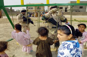MAJ Lawendowski from the Alaskan National Guard, assembles a swing set for Iraqi children living in an impoverished nighborhood, during a joint patrole humanitarian aid mission, in the town of Al Hillah, Iraq on May 14 2005. (U.S. Army Photo by SGT Hamilton, Arthur)