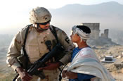 Sgt. Tonny R. Seals Sr., Mississippi Army National Guard, stops to chat with a local boy while on patrol in the hills surrounding Kabul. Seals is part of the 1/114th field artillery unit now serving as force protection in Afghanistan. (by U.S. Army Sgt. Benjamin T. Donde)