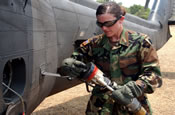 Spc. Kimberlin Devin, from 1st Battalion, 106th Aviation Regiment, Illinois Army National Guard, fuels a UH-60 Black Hawk helicopter in preparation for a mission during Exercise New Horizons in El Salvador. May 2, 2006 (by Spc. Cristhian Del Pino)