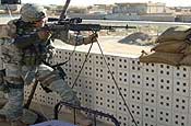 Sgt. Chris Walsh, from the Wyoming Army National Guard Police Training Team, provides overwatch security for fellow Soldiers in Sekeik, Iraq. (By Spc. Billy Brothers)