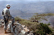 U.S. Army Spc. Gregory Santos, with Charlie Company, 1st Battalion, 294th Light Infantry Regiment, stands guard in Arta, Djibouti, Oct. 5, 2006. Santos is currently assigned to Combined Joint Task Force - Horn of Africa where he and other Soldiers of the Guam Army National Guard are teaching a 21-day mechanics course to Djiboutian army soldiers. (U.S. Navy photo by Chief Mass Communication Specialist Eric A. Clement)