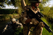 An Oregon Army National Guardsmen (left), trains a member of the Afghan National Army, Aug. 2008, near the Helmand Province, Afghanistan, during Operation Enduring Freedom. (Photo by Charles Eckert)