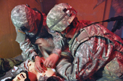  First Army trainers from the 189th Infantry Brigade utilize strobe lights, smoke machines, combat sound effects and computerized dummies during the combat lifesaver course in order to create an environment of sensory overload as part of the Provincial Reconstruction Team’s training at Camp Atterbury, Ind. (U.S. Army photo by Spc. Tim Sproles)