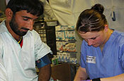 Spc. Jessica Guzzetti, a Task Force Talon medic from the 1-183rd Aviation Battalion from Boise, Idaho, tends to the needs of a local at a free clinic in Afghanistan. 