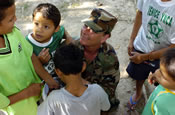 Lancaster, Ohio resident Sgt. Natasha Swarts with the Ohio Army National Guard's 186th Engineering Detachment passes out candy April 11, to children of the Ni-os de la Luz orphanage in La Ceiba, Honduras. (U.S. Army Photo by Spc. Benjamin Cossel, 196th Mobile Public Affairs Detachment)