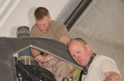 Cpl. Nate Carter and Staff Sgt. Christopher Chambers, both Mississippi National Guardsmen assigned to the 277th Aviation Support Battalion, install a swash blade on a CH-47 Chinook helicopter at Bagram Airfield, Afghanistan.(by Master Sgt. Doug Sample)