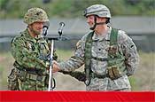 Lt. Col. Edward Tanguy (right), commander of the Oregon National Guard's 2nd Battalion, 162nd Infantry, shakes hands with Lt. Col. Shizuo Sekine, commander of Japan's 2nd Infantry Battalion, 1st Airborne Brigade during the Orient Shield 2007 opening ceremony Monday at Sekiyama Maneuver Area, Japan.