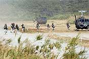 Members of C Company, 2-162 Inf. disembark from a helicopter during Orient Shield's first day of training Tuesday.
