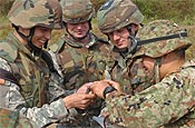 Oregon National Guard Soldier Spc. Alvaro Castaneda (left) of Springfield shares a Tootsie Roll with a member of the Japanese Ground Self Defense Force (right) as Spc. Orlo Flock of Eugene (second from left) and Sgt. James Cutshall of Elmira watch. Many Oregon National Guard Soldiers are establishing lasting friendships with their Japanese counterparts during the bilateral training and cultural exchanges of Orient Shield. (Photo by Staff Sgt. Russell Bassett, 115th Mobile Public Affairs Detachment)