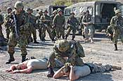 Oregon National Guard Soldiers role play for Japanese soldiers during Traffic Control Point training Tuesday. Many of the Guardsman deployed to Iraq in 2004 and passed on the knowledge learned there to their Japanese counterparts.