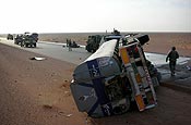 Soldiers with C Company, 1st Battalion, 133rd Infantry Regiment, Iowa Army National Guard, assess the scene following an improvised explosive device attack on their convoy June 11, 2006, which knocked over a fuel tanker they had been escorting to Camp Al Asad. Sgt. Joedy Dennis, one of the Humvee truck commanders, helped rescue the driver of the fuel tanker. U.S. Army photo courtesy of 1st Battalion, 133rd Infantry Regiment.